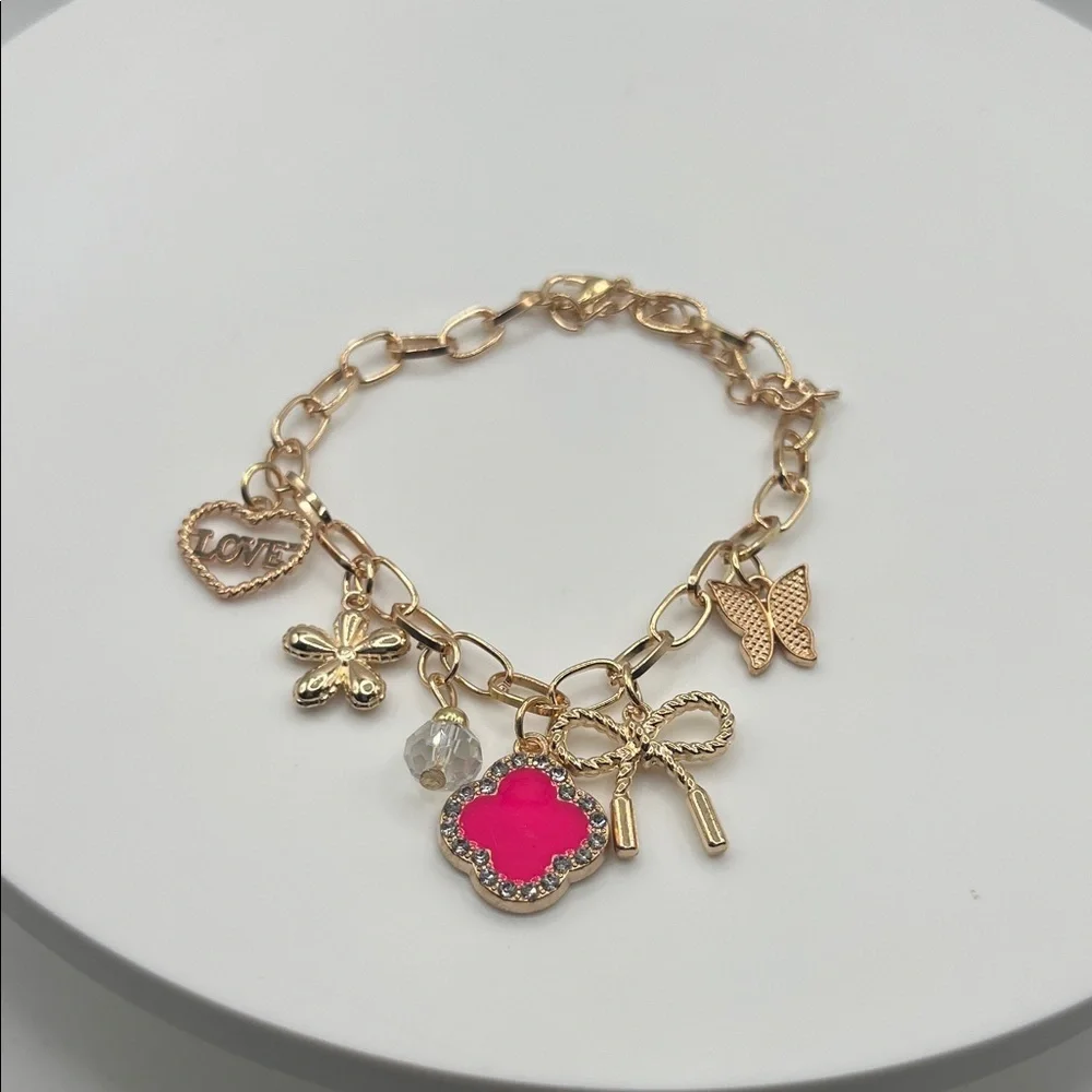 849. Gold Charm Bracelet with Pink Accent